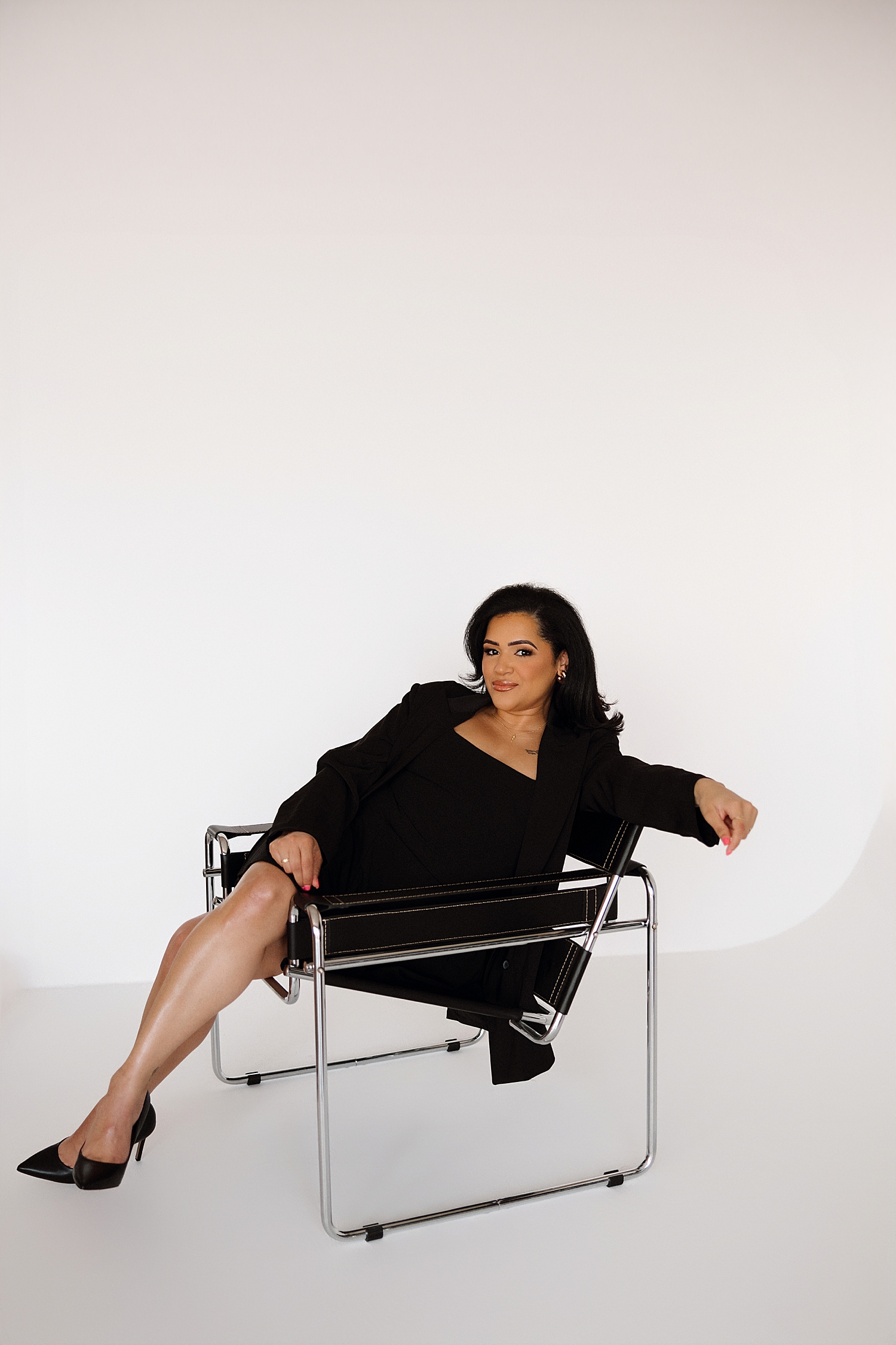 business woman sits in chair by Love Kay Collective