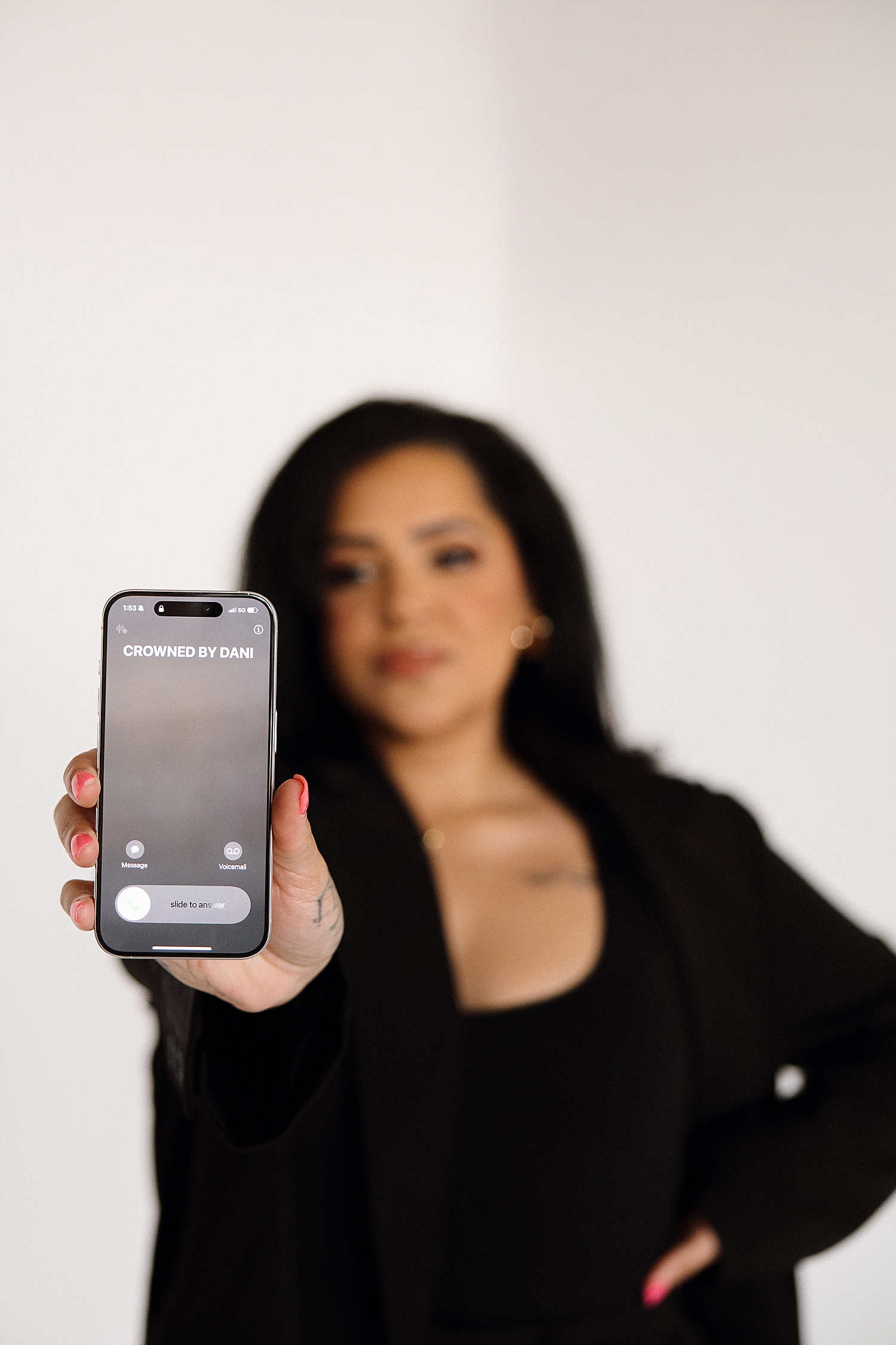 woman holds up phone with call incoming by Love Kay Collective