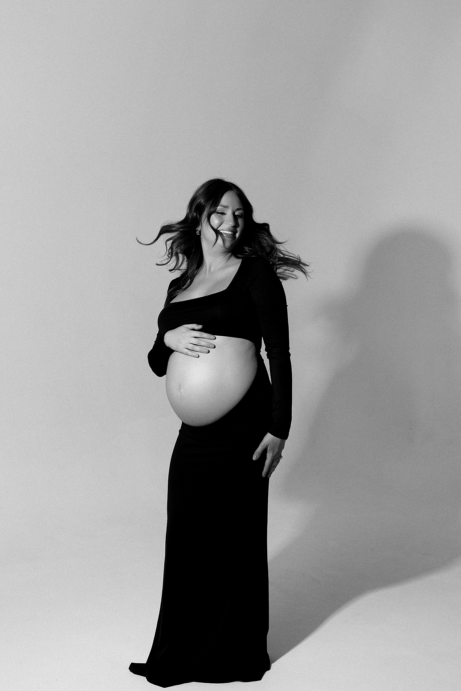 mom spins her hair around in studio glamour lighting