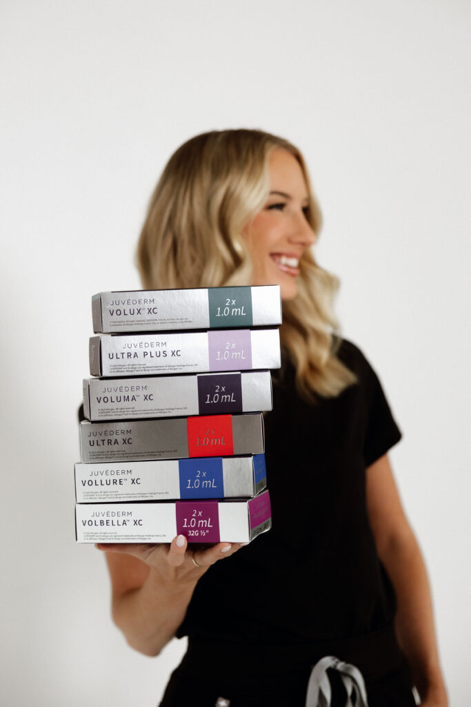 Confident female injector captured in scrubs as part of a modern, clean branding photo session in Florida.

