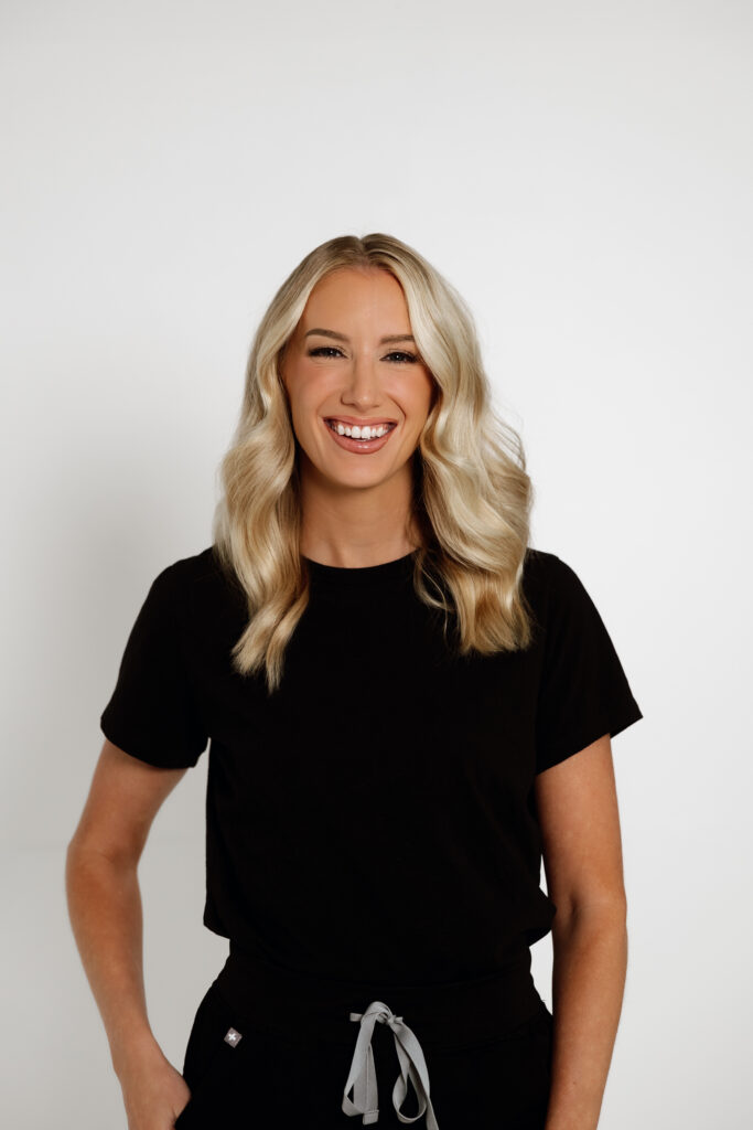 Board-certified nurse practitioner posing in black scrubs during medical branding shoot.